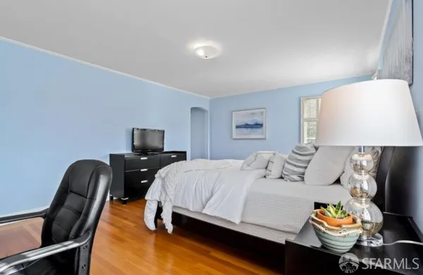 a bedroom with a bed and a lamp