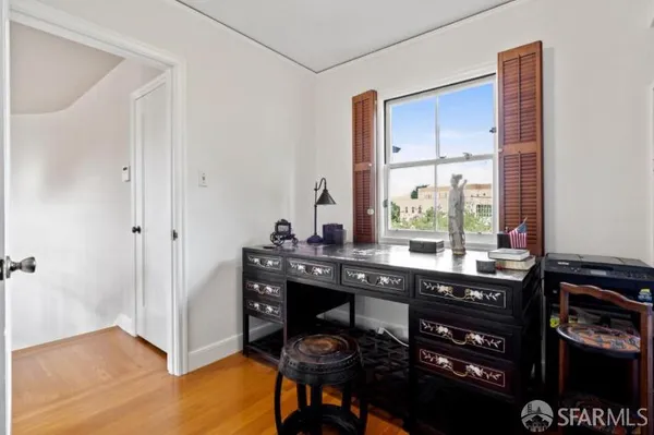 a bedroom with furniture and a window