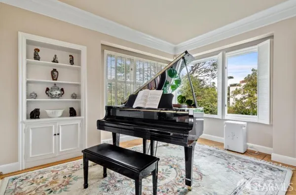 a living room with furniture a window and a potted plant