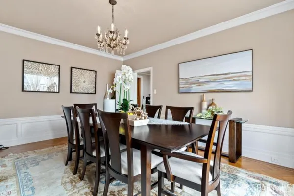a view of a dining room with furniture and chandelier