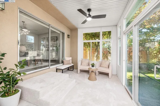 a backyard of a house with table and chairs