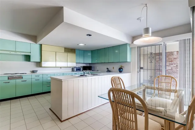 a kitchen with cabinets and window
