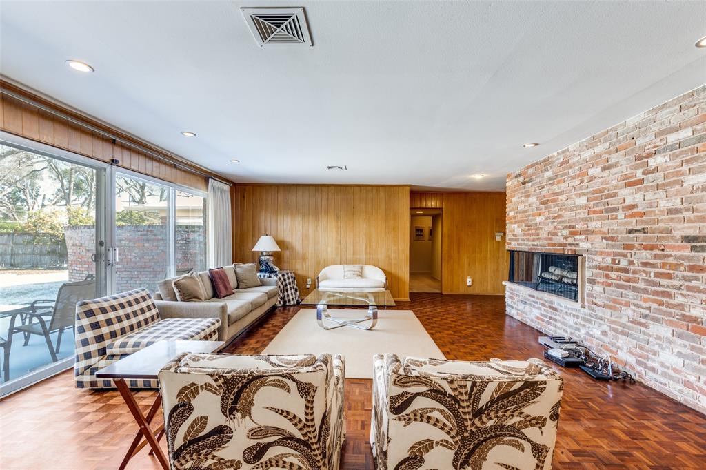 7215 Currin Drive Dallas, TX 75230 - Photo 16 of 35 a spacious bedroom with a bed and a fireplace