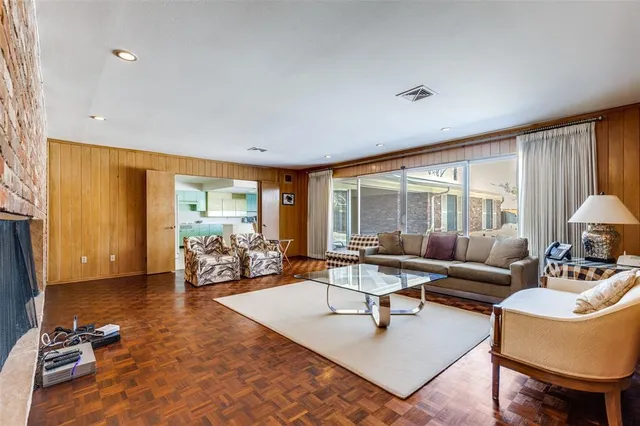 a living room with furniture and floor to ceiling window