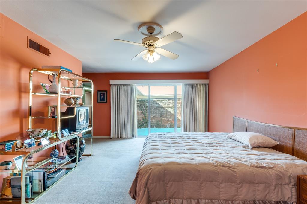 7215 Currin Drive Dallas, TX 75230 - Photo 20 of 35 a bedroom with a bed and a chandelier