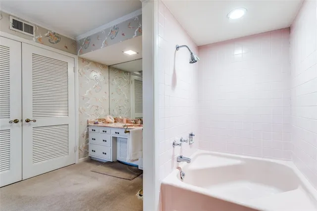 a bathroom with a bathtub and a sink
