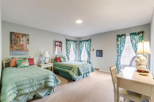 a bedroom with two beds and a table