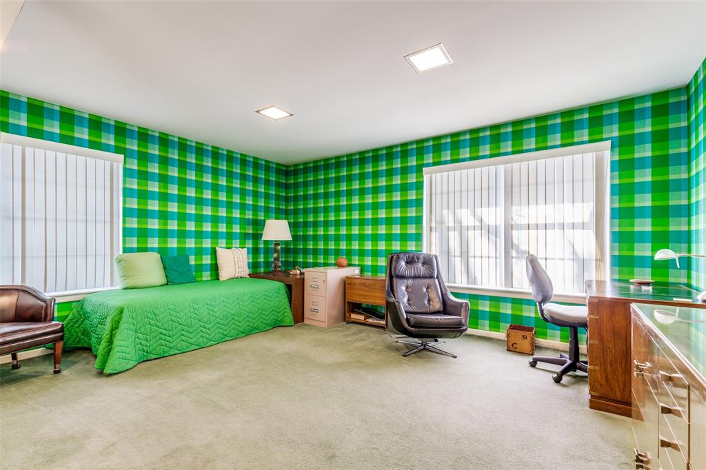 7215 Currin Drive Dallas, TX 75230 - Photo 27 of 35 a living room with a bed and large windows