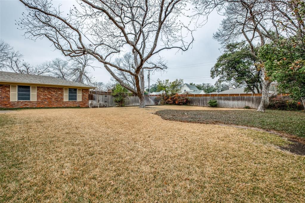 7215 Currin Drive Dallas, TX 75230 - Photo 30 of 35 a front view of house with yard and trees around