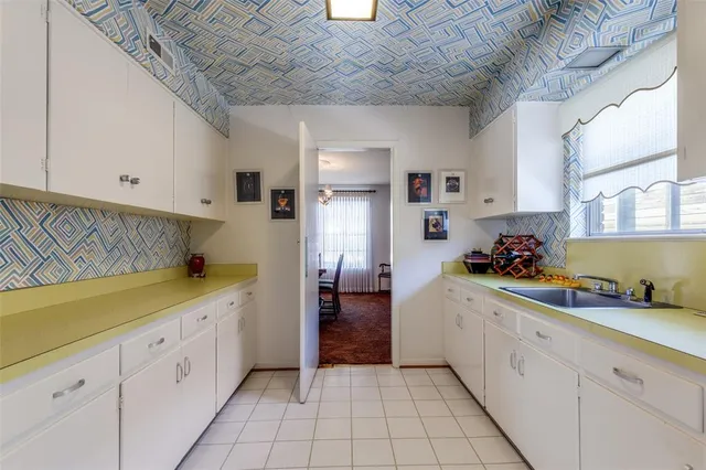 a kitchen with a sink and cabinets