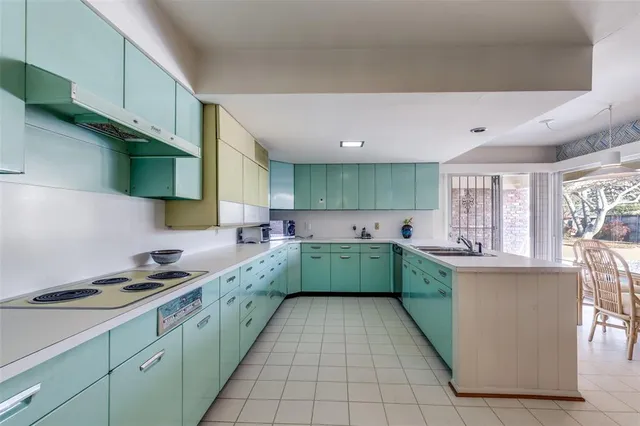 a kitchen with a sink a stove and cabinets