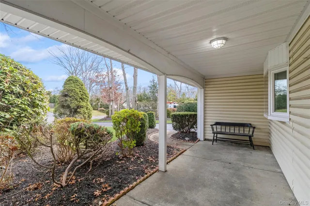 a view of a porch with furniture and a garden