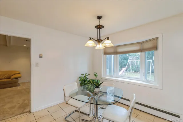 a dining room with furniture and window