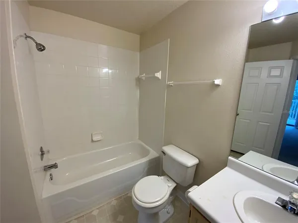 a white toilet sitting next to a bath tub