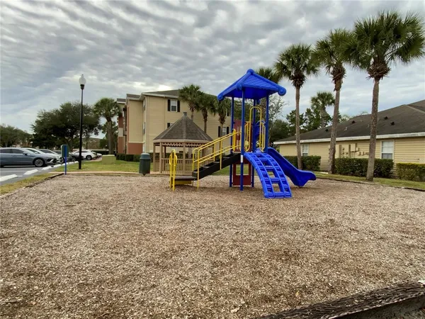 a view of outdoor space with playground and green space