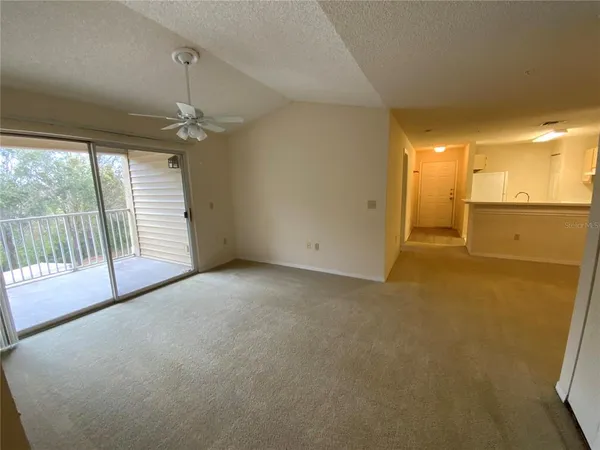 a view of a livingroom with an empty space and a fireplace