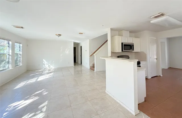a view of a kitchen with a sink dishwasher and a refrigerator
