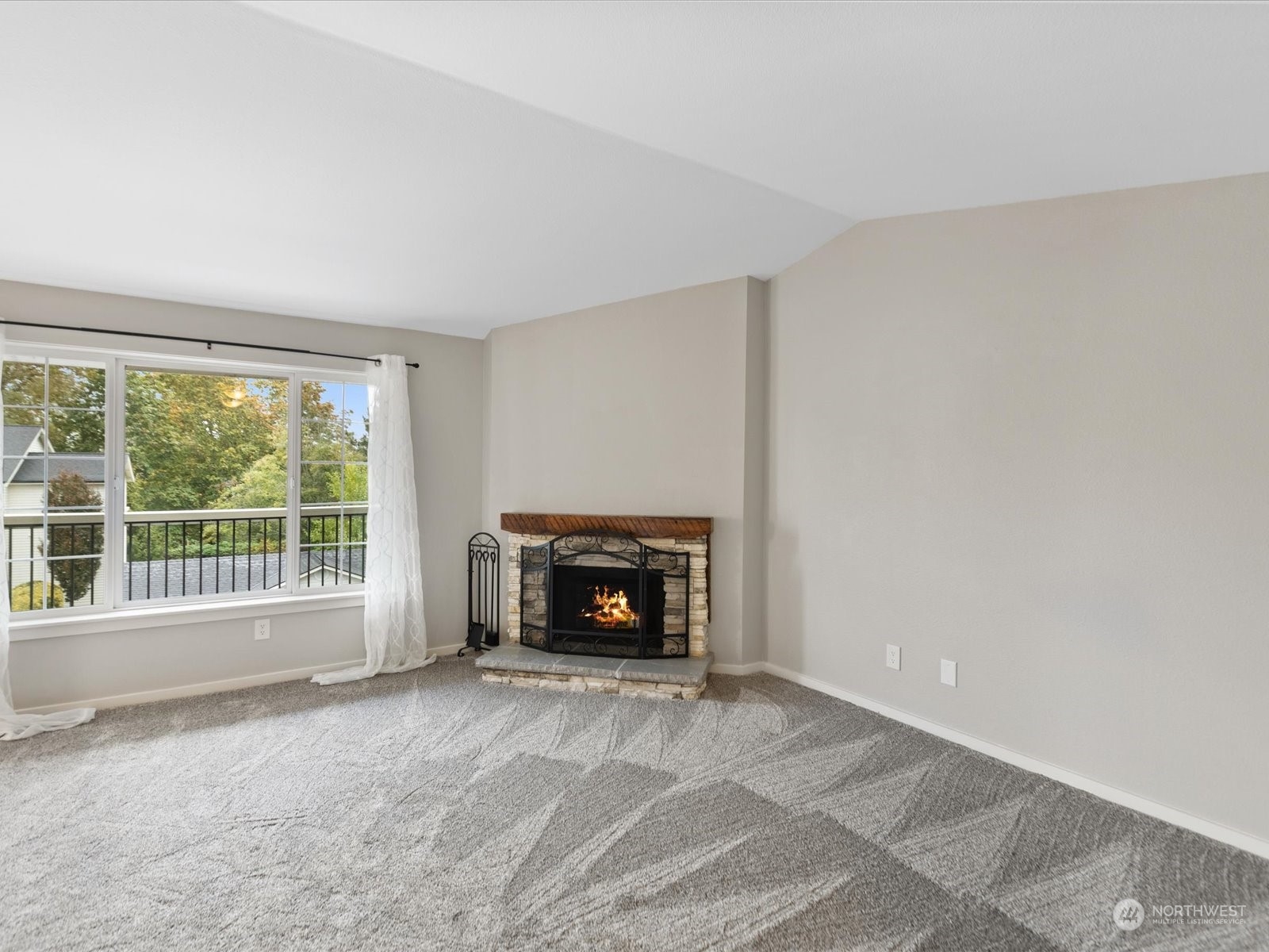 12404 East Gibson Road, Unit J303 Everett, WA 98204 - Photo 11 of 40 a view of an empty room with a fireplace and a window