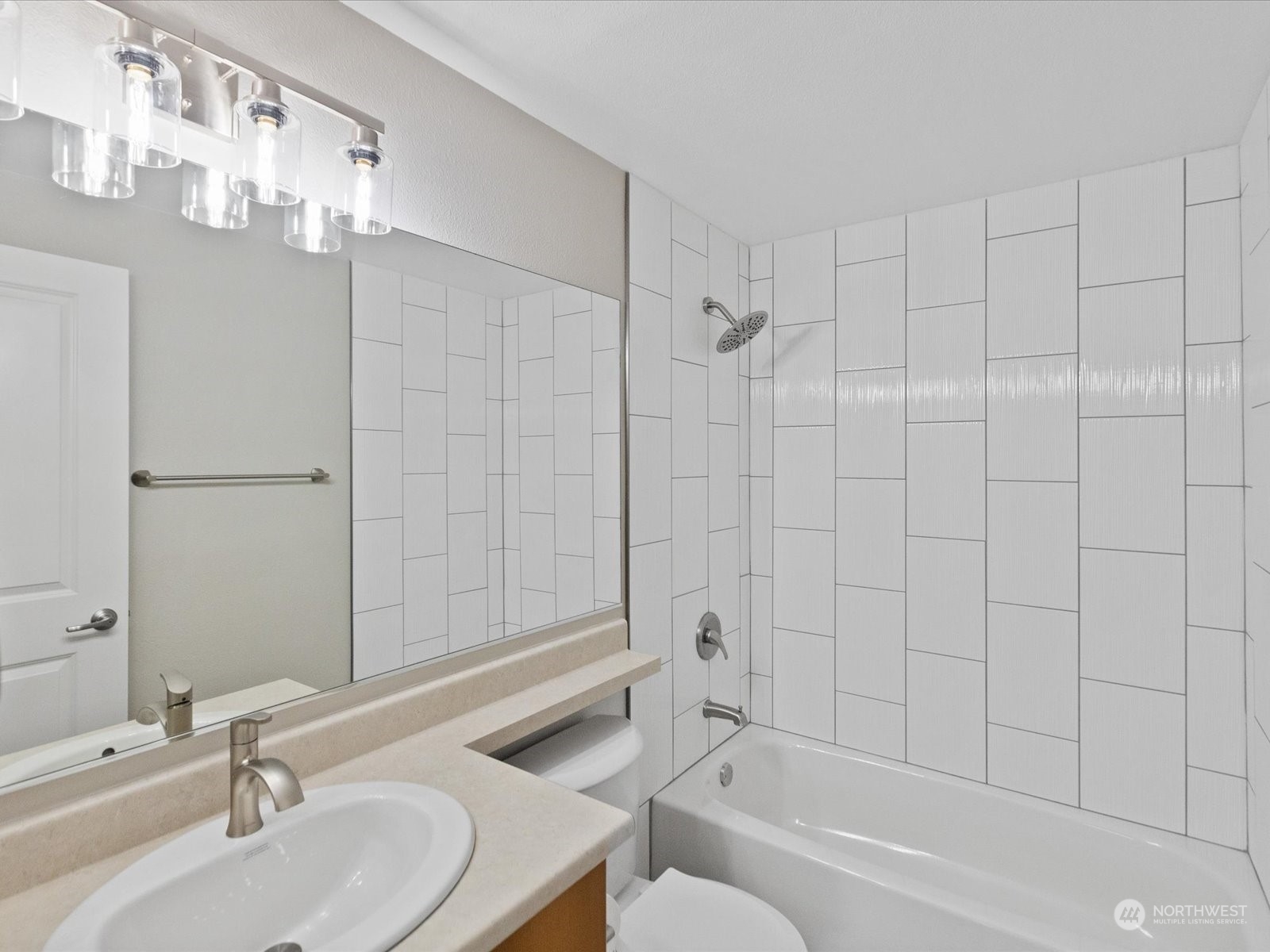 12404 East Gibson Road, Unit J303 Everett, WA 98204 - Photo 13 of 40 a bathroom with a sink a toilet and shower