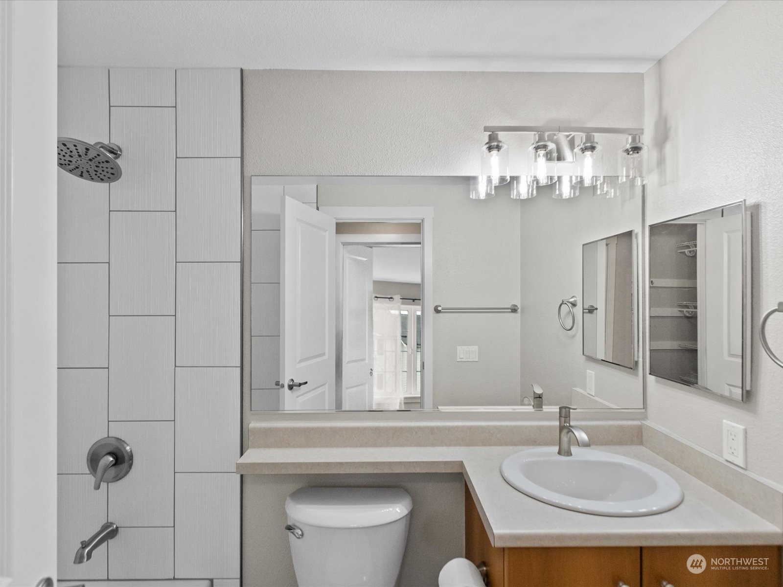 12404 East Gibson Road, Unit J303 Everett, WA 98204 - Photo 16 of 40 a bathroom with a sink a toilet and shower
