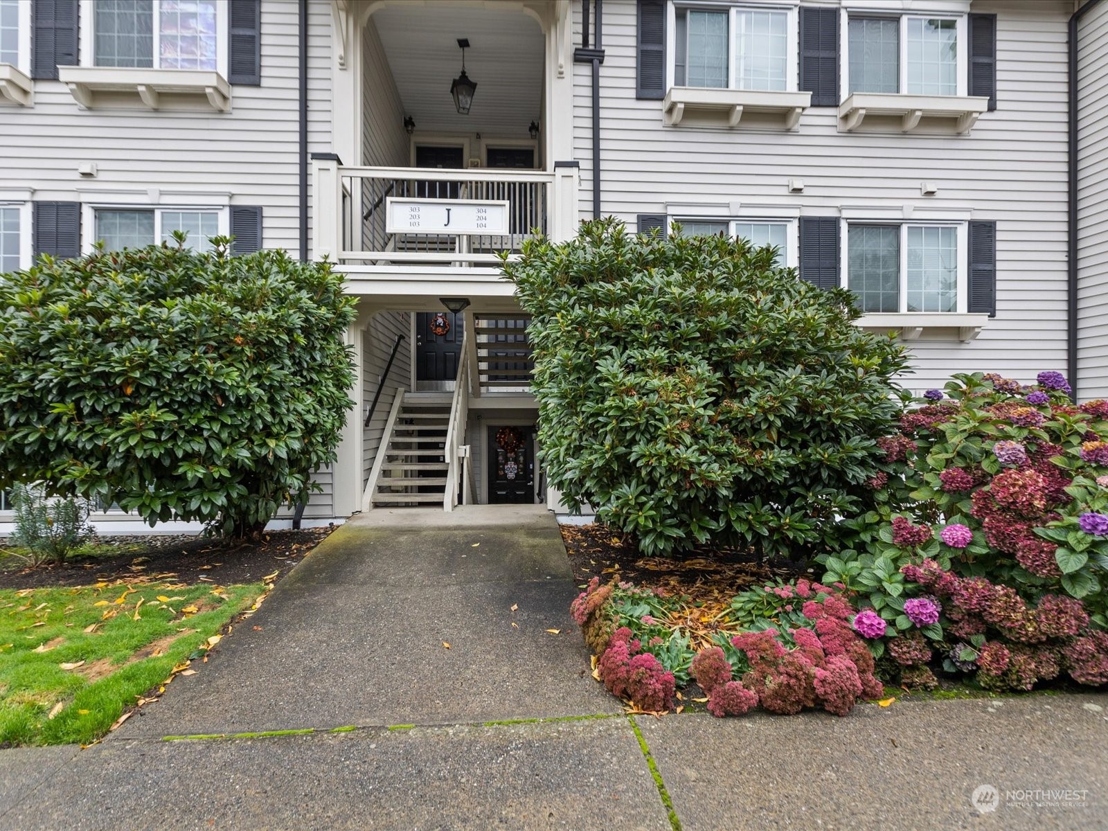 12404 East Gibson Road, Unit J303 Everett, WA 98204 - Photo 2 of 40 a front view of a house with a yard