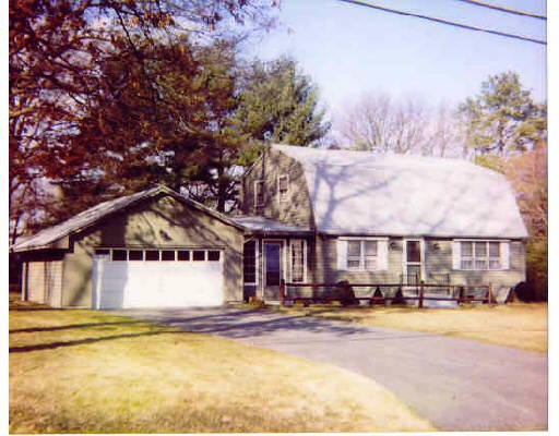 a view of a house with a big yard and large trees