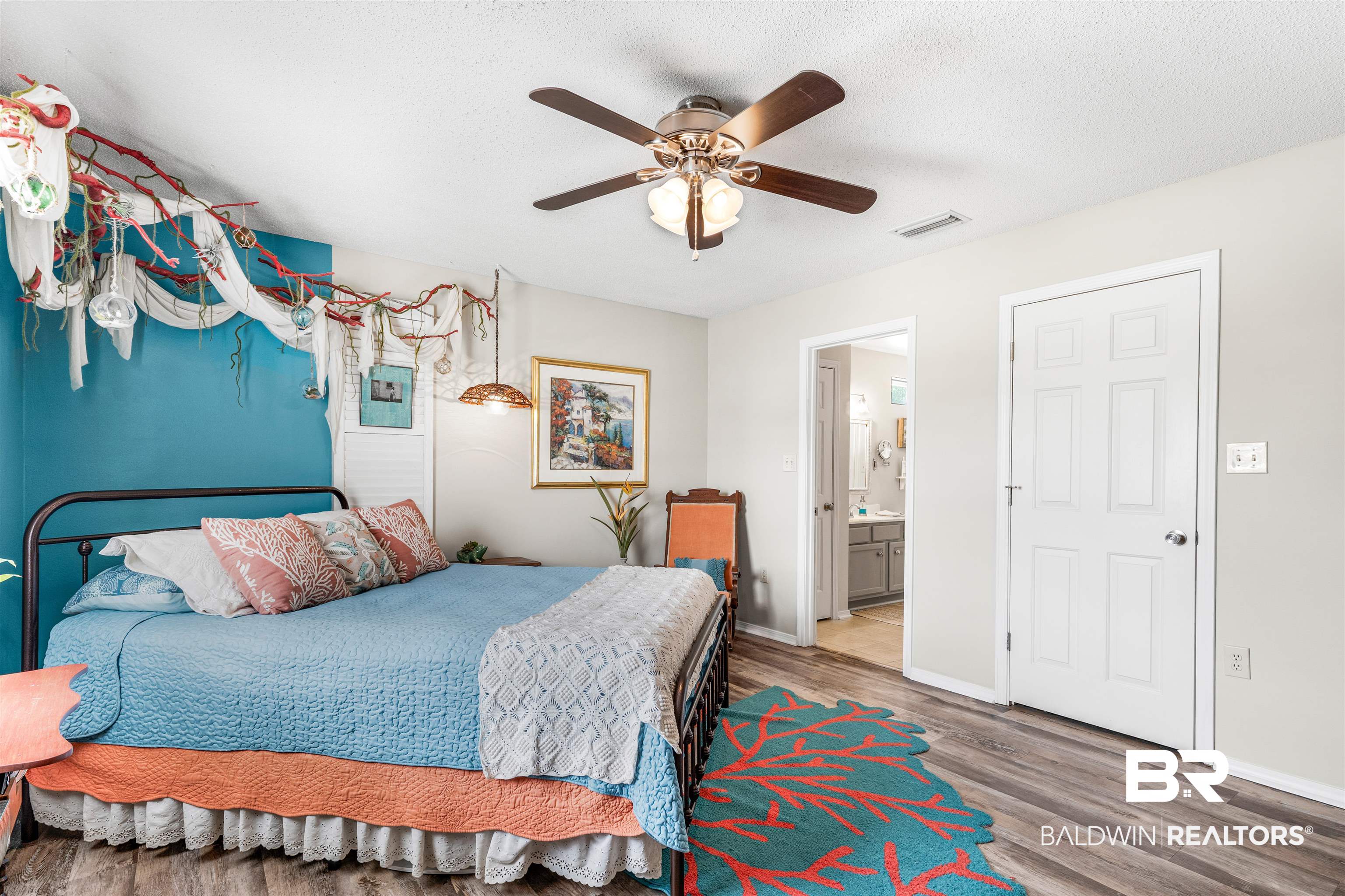 518 Ariel Avenue Foley, AL 36535 - Photo 21 of 47 Bedroom featuring ceiling fan, hardwood / wood-style flooring, connected bathroom, and a textured ceiling