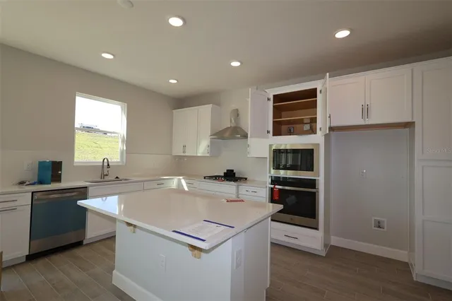 a kitchen that has a sink and a stove in it