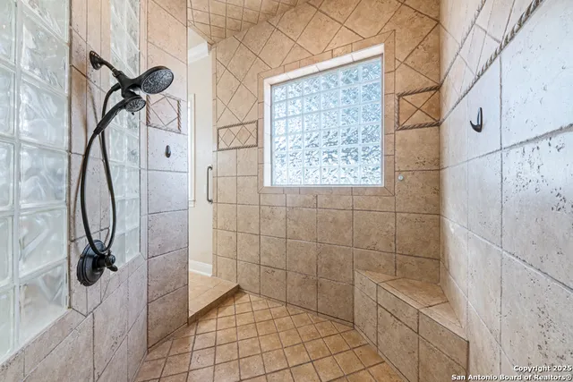 a living room with furniture a chandelier and a window