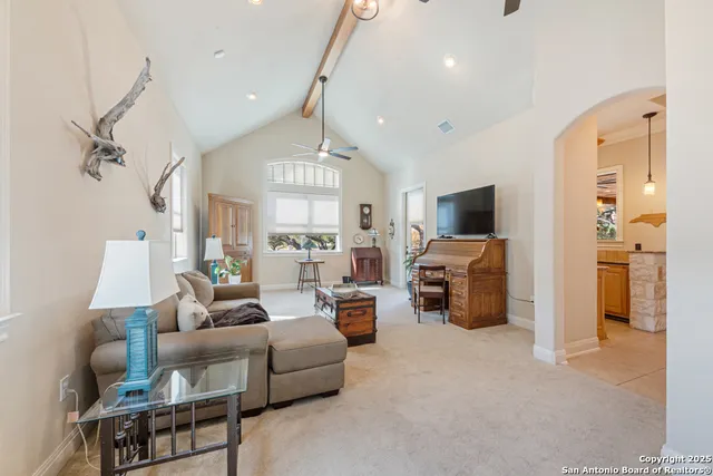 a view of grassy field with benches and trees all around