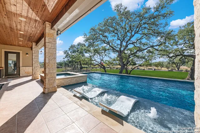 an aerial view of a house with a yard and outdoor seating