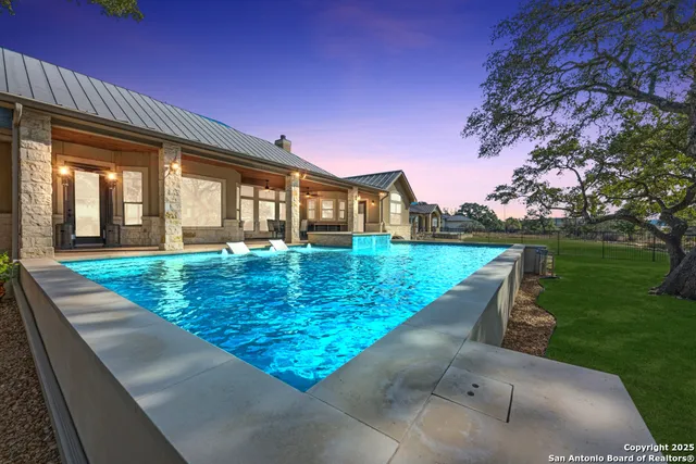 an aerial view of house with yard and outdoor seating