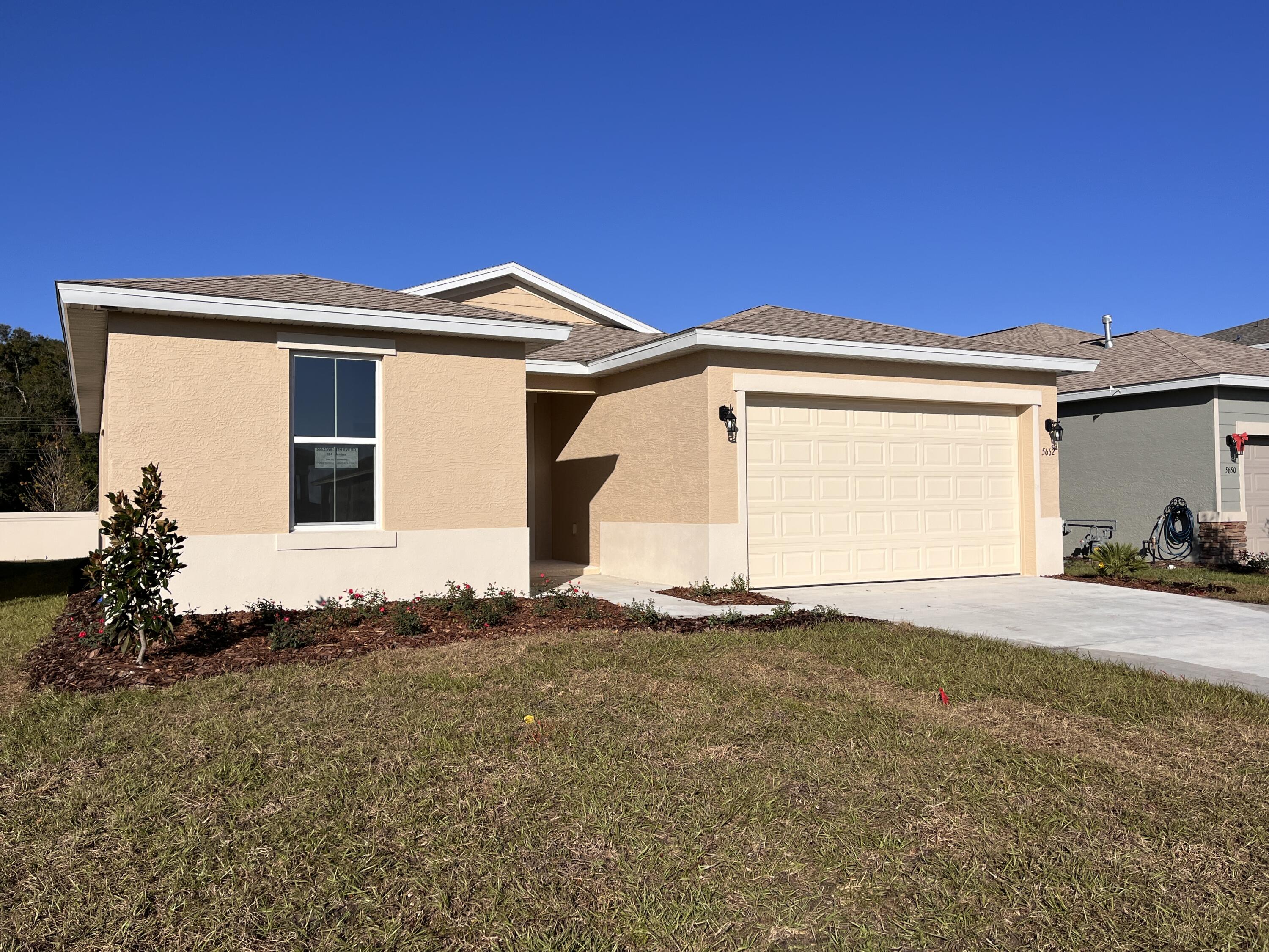 5662 Southwest 78th Ave Road Ocala, FL 34474 - Photo 1 of 15 a front view of a house with a yard