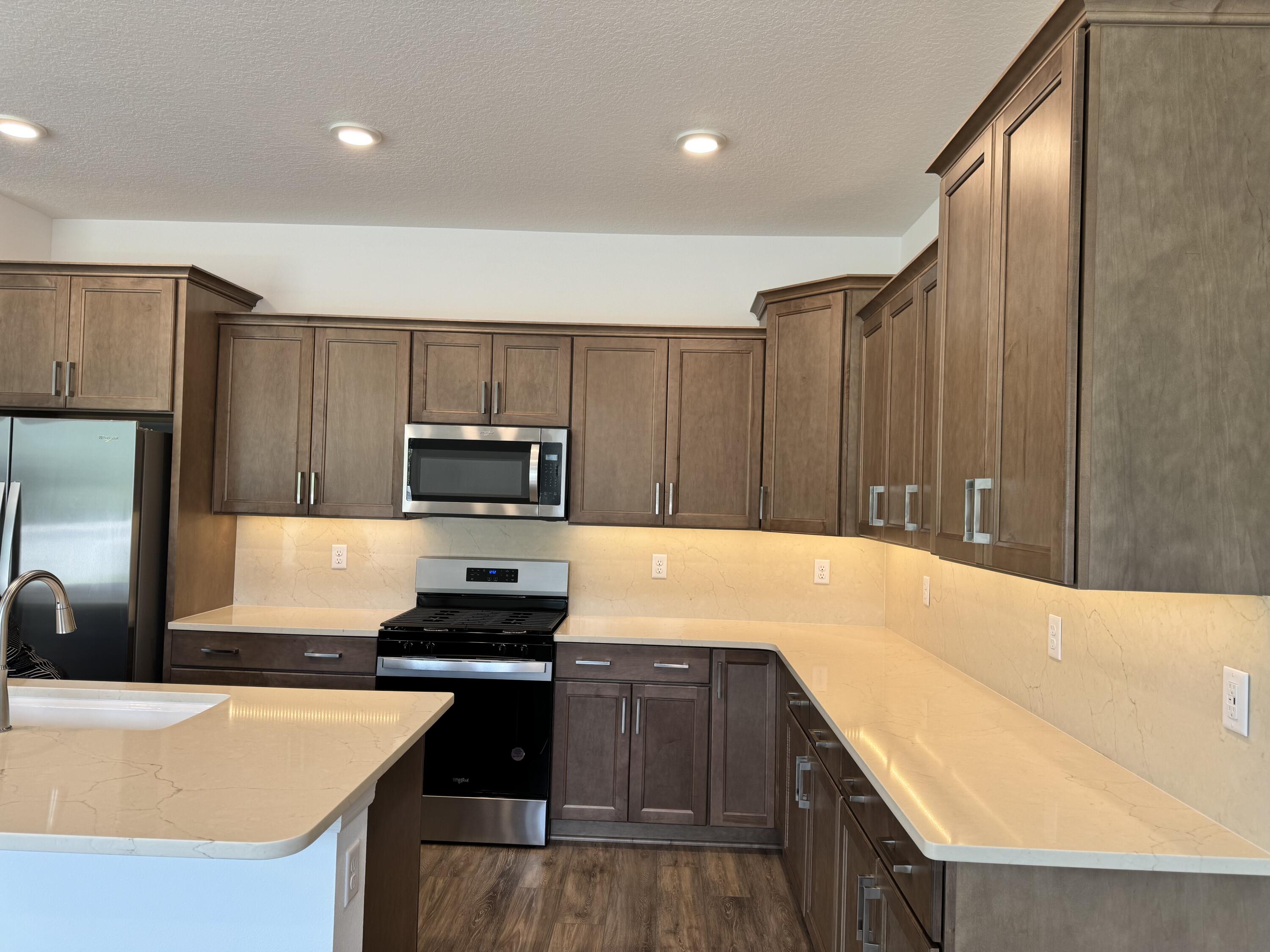 5662 Southwest 78th Ave Road Ocala, FL 34474 - Photo 2 of 15 a kitchen with kitchen island a counter top space cabinets and stainless steel appliances
