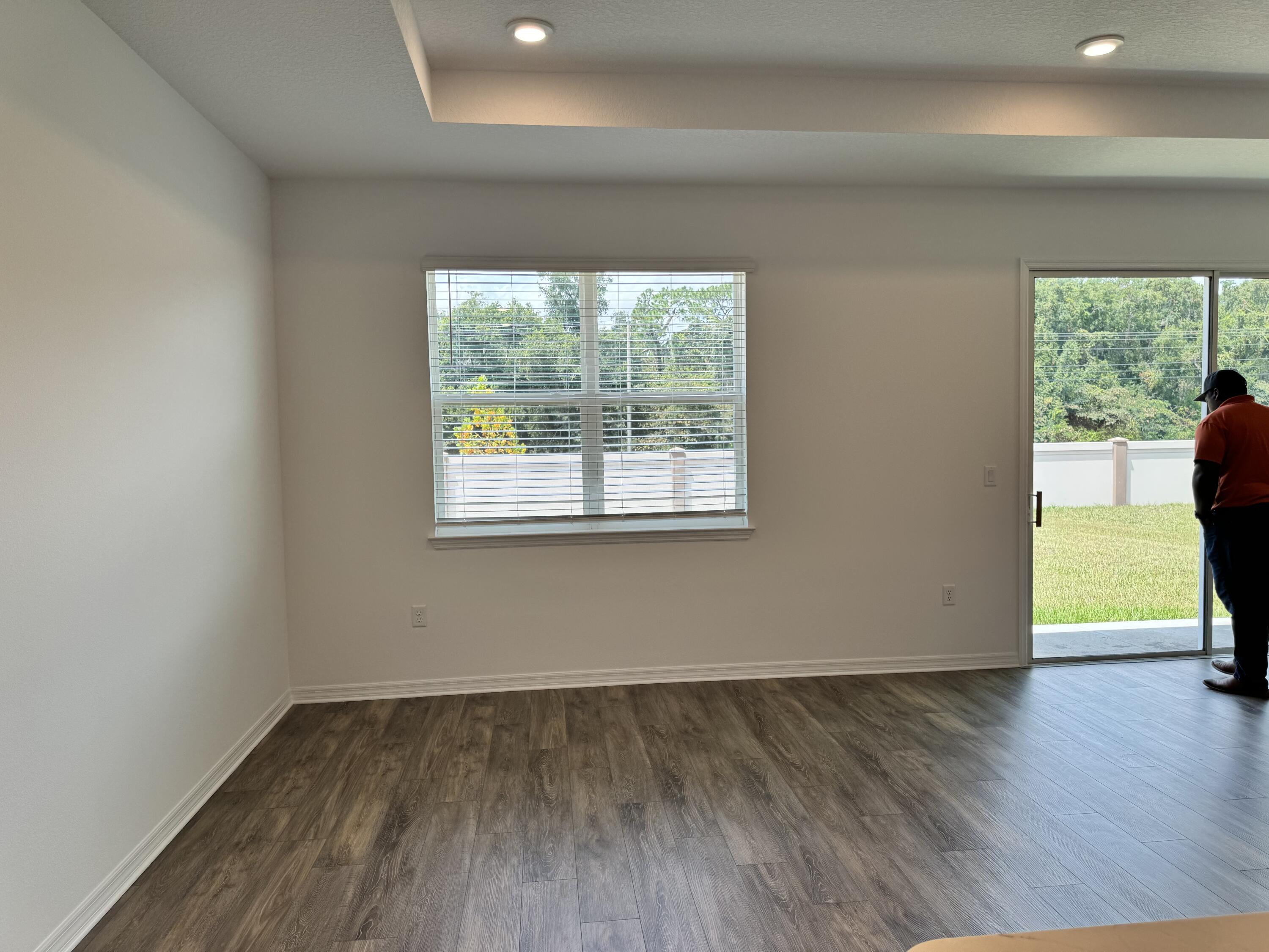 5662 Southwest 78th Ave Road Ocala, FL 34474 - Photo 4 of 15 a view of an empty room with wooden floor and a window