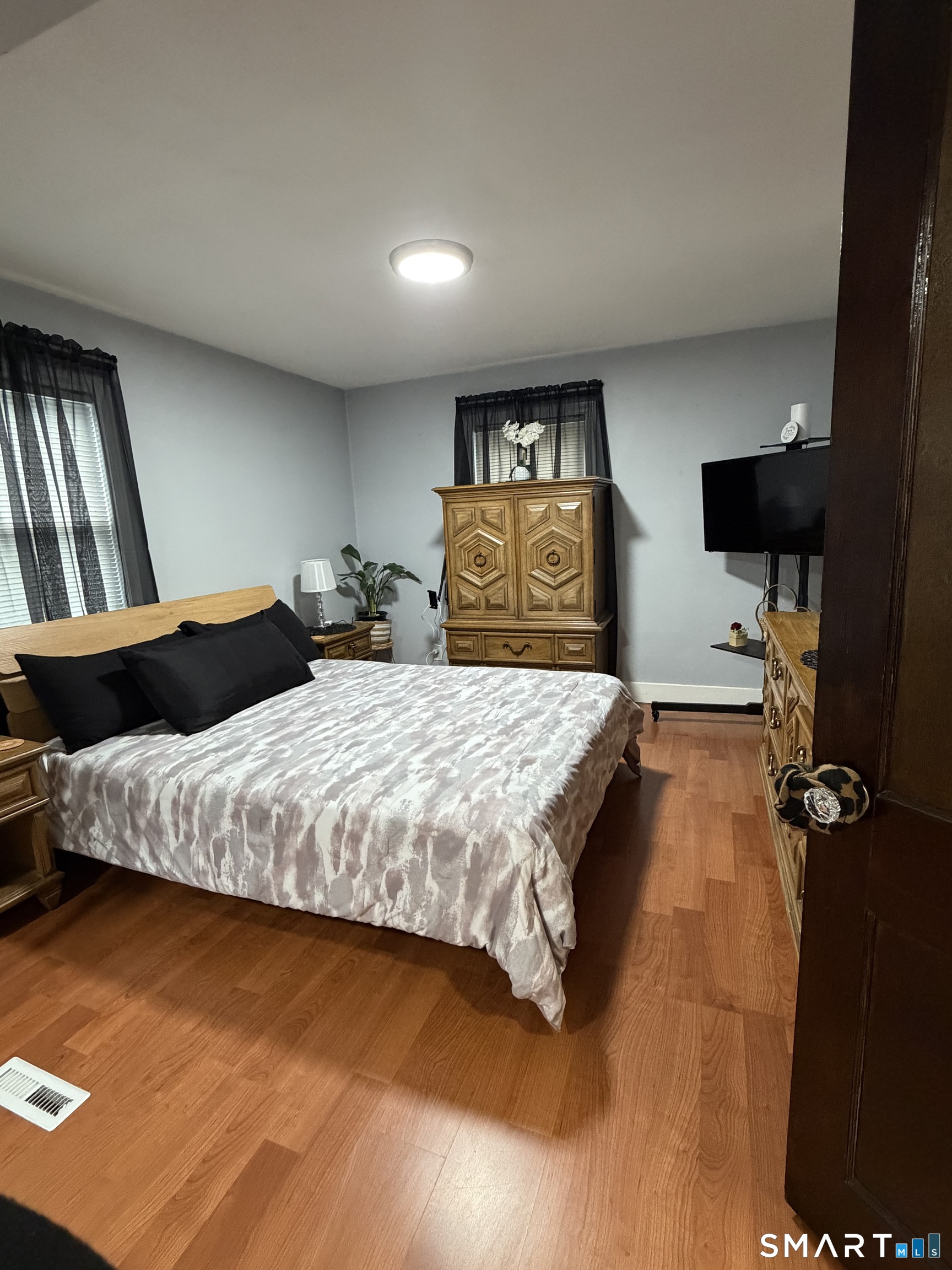 55 New Hanover Avenue Meriden, CT 06451 - Photo 26 of 33 a spacious bedroom with a bed and wooden floor