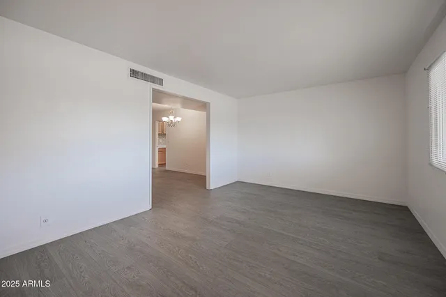 a view of an empty room and wooden floor