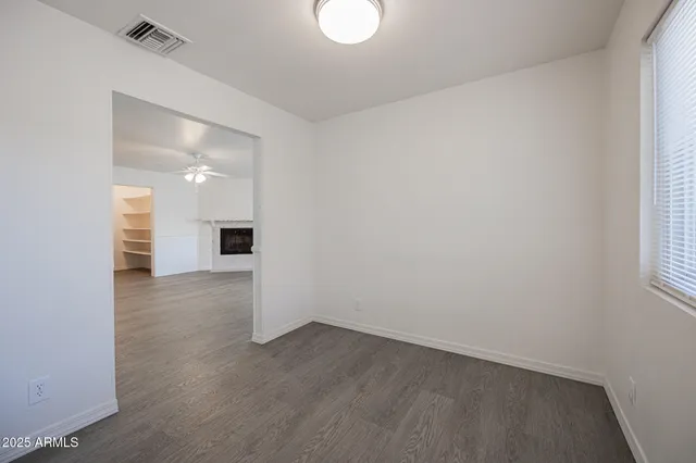 a view of a room with wooden floor and a window