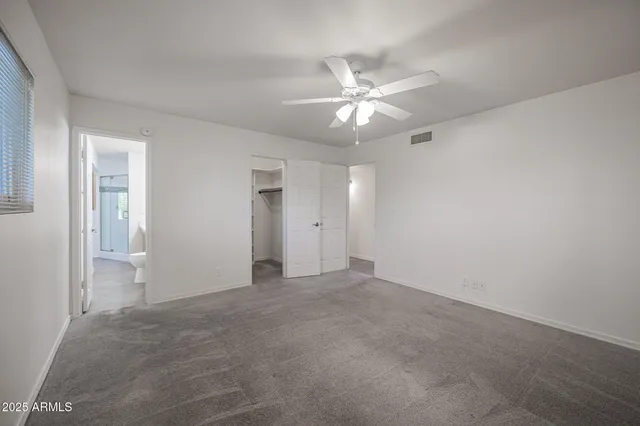 a view of an empty room with a fan