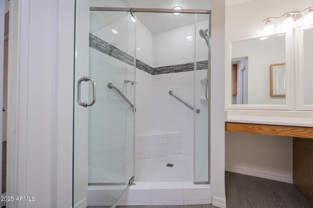 a bathroom with a glass shower door