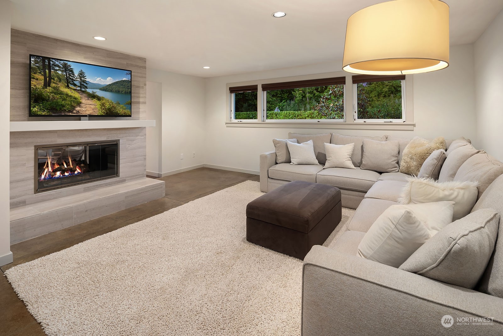 3001 Hunts Point Road Hunts Point, WA 98004 - Photo 18 of 33 a living room with furniture a flat screen tv and a fireplace