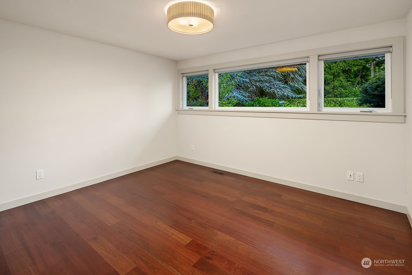 3001 Hunts Point Road Hunts Point, WA 98004 - Photo 20 of 33 an empty room with wooden floor and windows