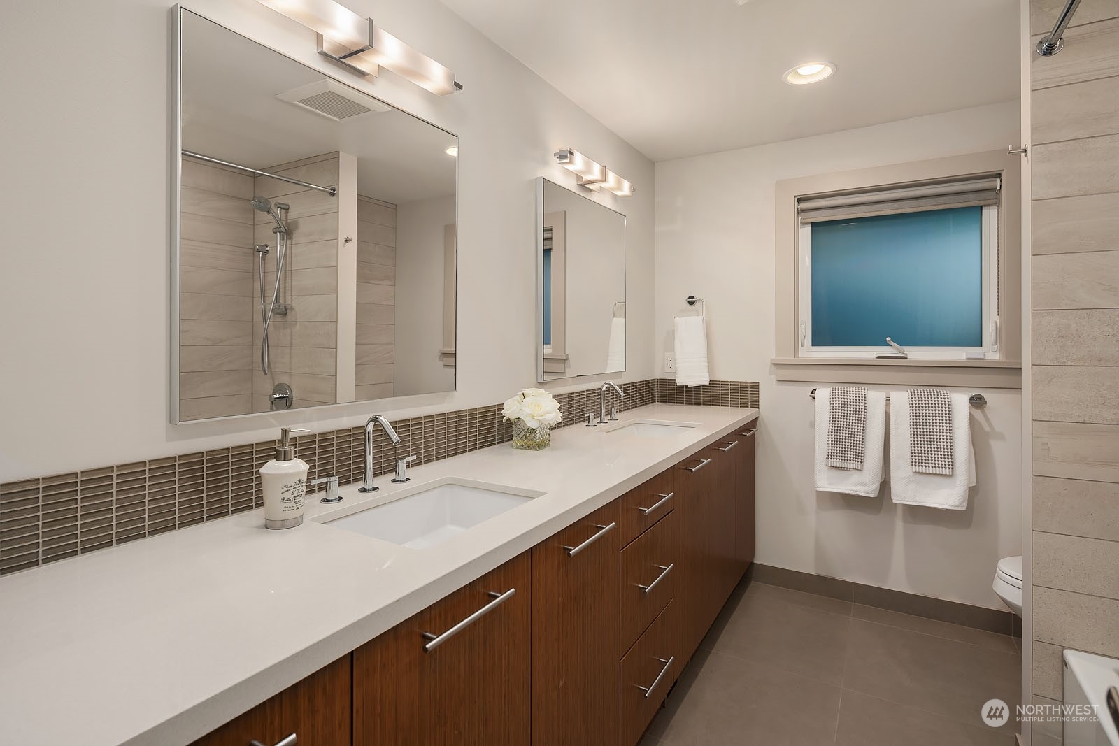 3001 Hunts Point Road Hunts Point, WA 98004 - Photo 22 of 33 a bathroom with a sink a vanity and a mirror