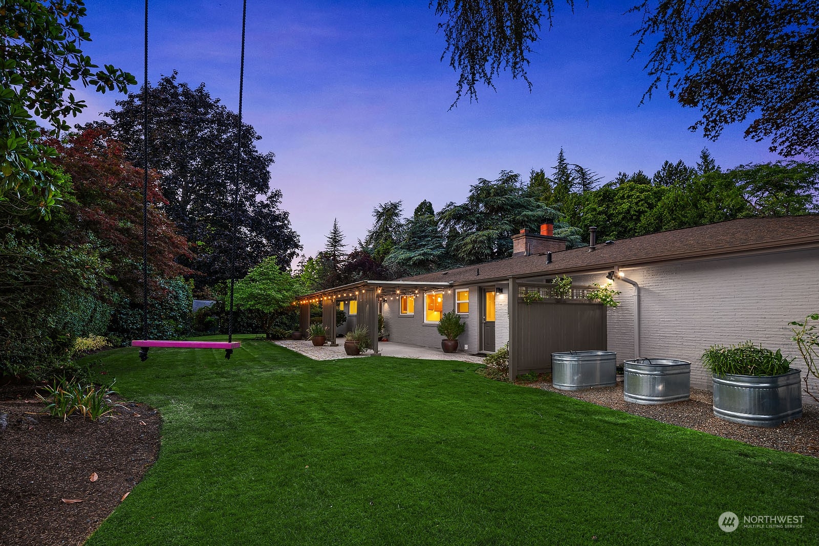 3001 Hunts Point Road Hunts Point, WA 98004 - Photo 31 of 33 a view of a backyard with a table and chairs and potted plants