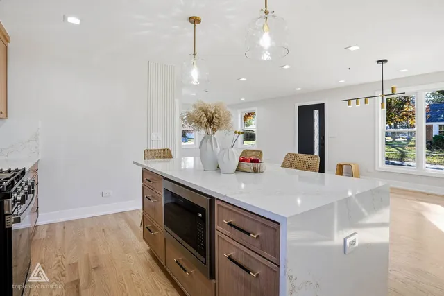 a kitchen with stainless steel appliances granite countertop a sink a refrigerator and a stove