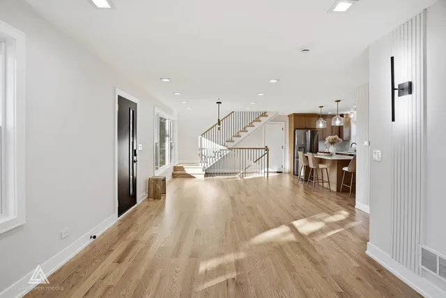 a view of a living room and kitchen with stainless steel appliances