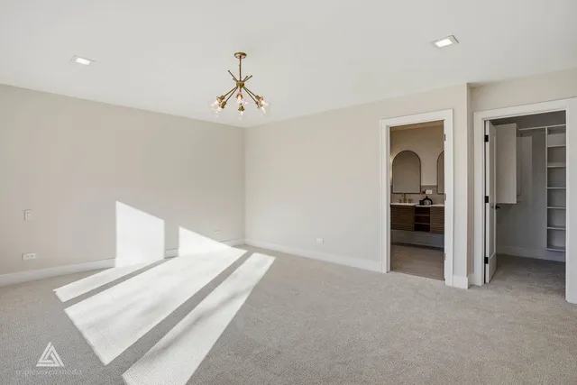 a view of an empty room with chandelier