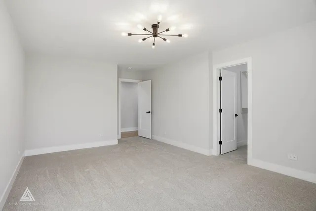 an empty room with windows and ceiling fan