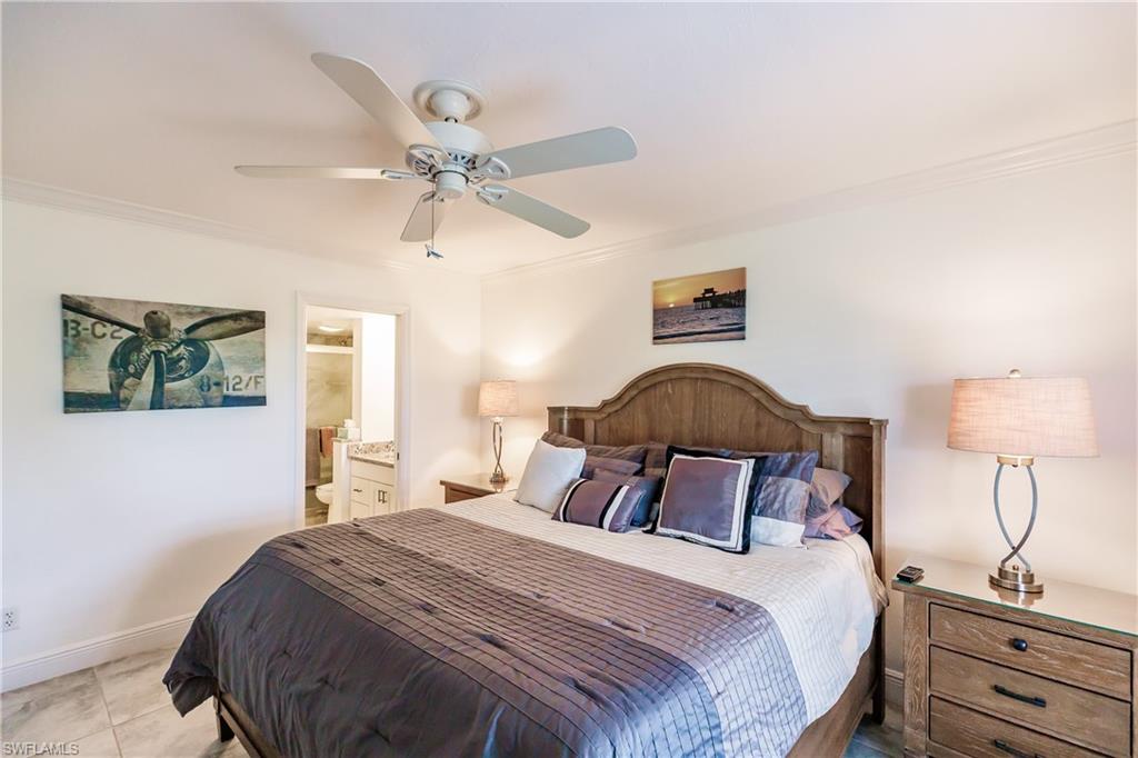 600 Neapolitan Way, Unit 454 Naples, FL 34103 - Photo 12 of 26 a bedroom with a bed and a window