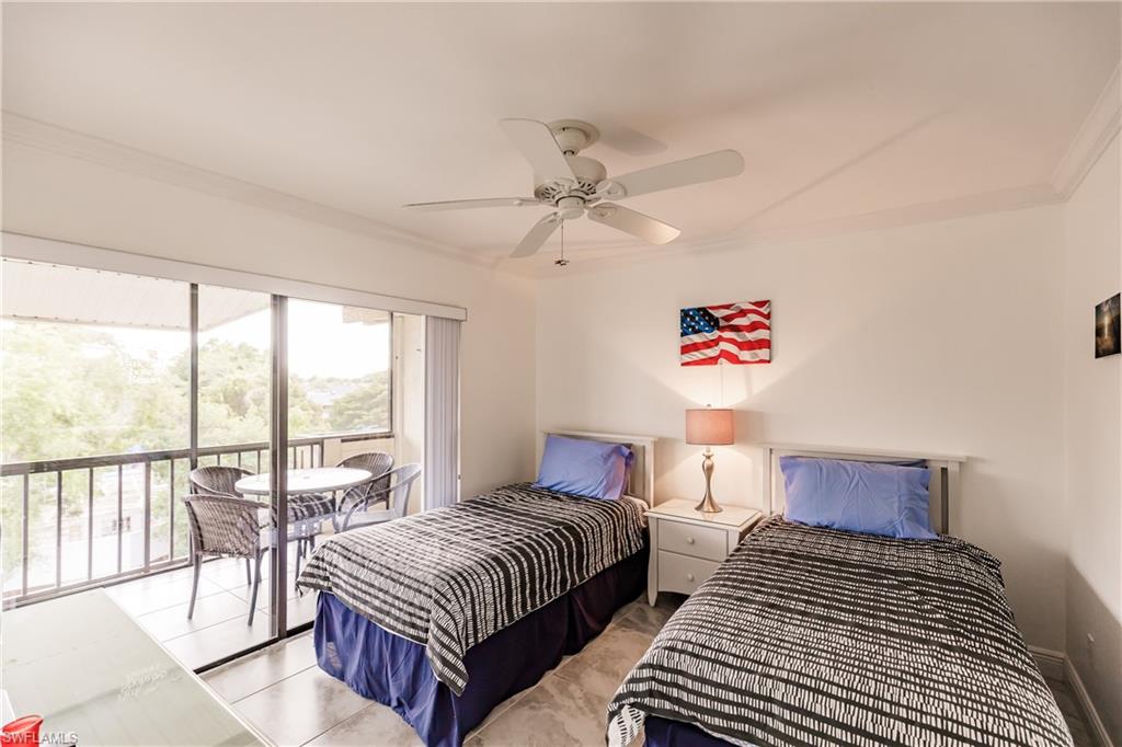 600 Neapolitan Way, Unit 454 Naples, FL 34103 - Photo 15 of 26 a bedroom with double bed and a large window